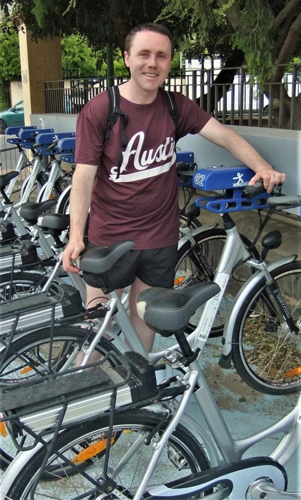David Curran, site author, standing in a row of bicycles
